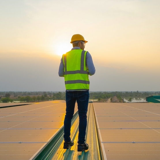 A roofer is performing a final check on a commercial roof